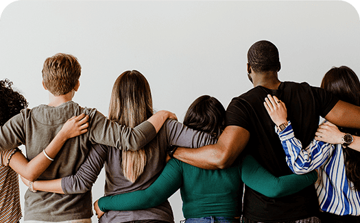 rearview-diverse-people-hugging-each-other